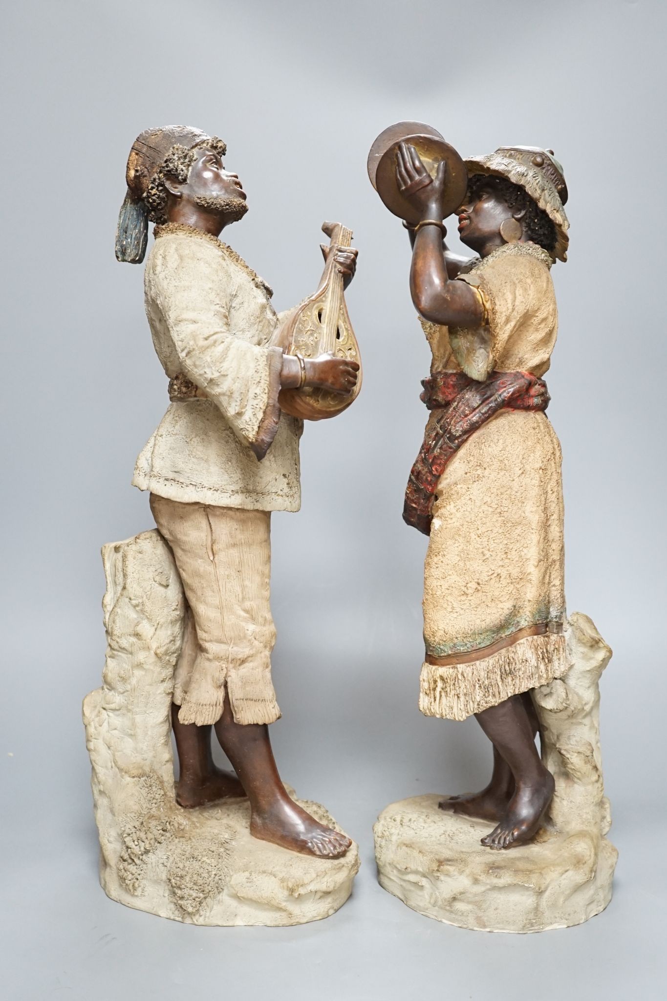 A pair of terracotta musician figures, incised numbers to base, 49cm